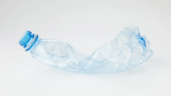 Crumpled plastic bottle on a light background — Stock Photo, Image