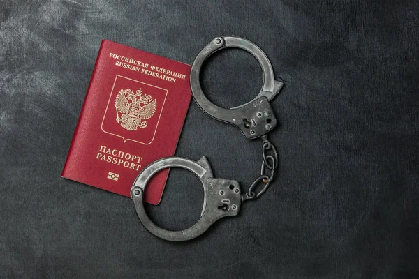 Passaporte russo com algemas em fundo preto — Fotografia de Stock