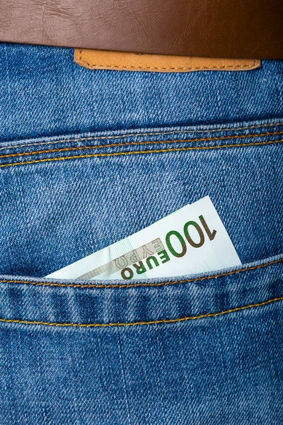 Closeup of one hundred Euro banknote peeking out of blue jeans b — Stock Photo, Image