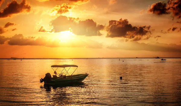 Boat in the sea against a beautiful bright red sunset. Travel an — Stock Photo, Image