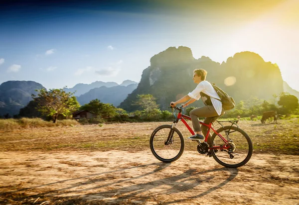 Happy tourist woman riding a bicycle in mountain area in Laos. T — Stock Photo, Image