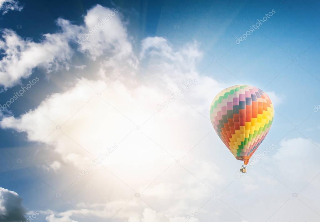 Beautiful bright striped balloon against the blue sky. Travel dr