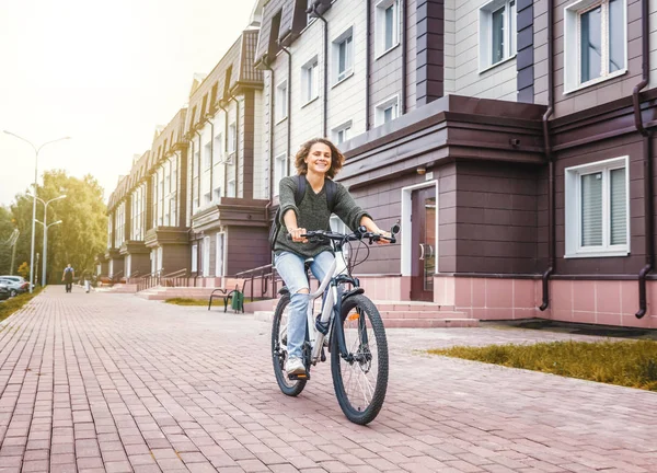 Güzel genç kız öğrenci bir kazak ve bir bicyc kot