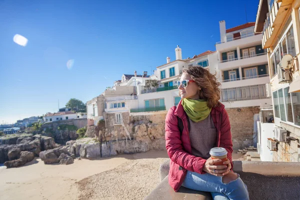 Beautiful young woman student tourist with a glass of coffee in — Stock Photo, Image