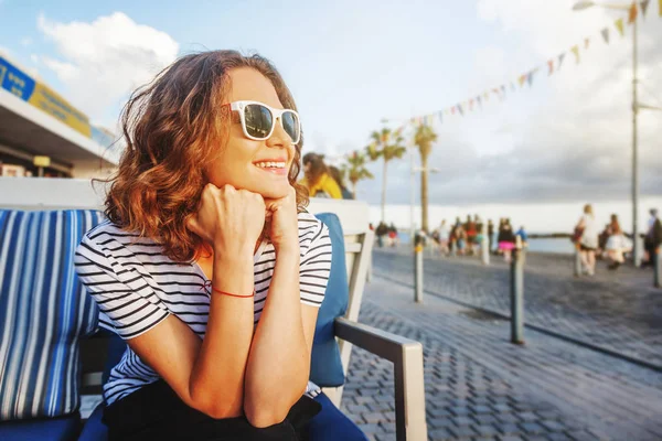 Gadis cantik muda dengan kaos bergaris-garis duduk di str — Stok Foto