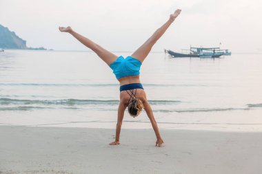 bir kız ellerinin kumlu bir plaj üzerinde duruyor, fr ile hayat sahiptir