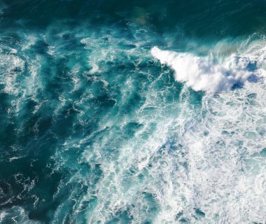 Turquoise seawater with foamy waves, picture from above, abstrac clipart