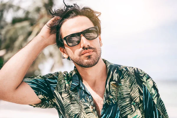 Stylish sexy young brunette man with a beard in a Hawaiian shirt — Stock Photo, Image