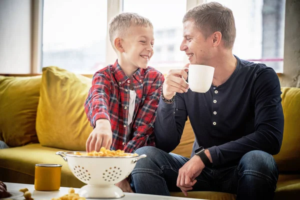 Happy young father and son boy 8 years old joyfully chatting at