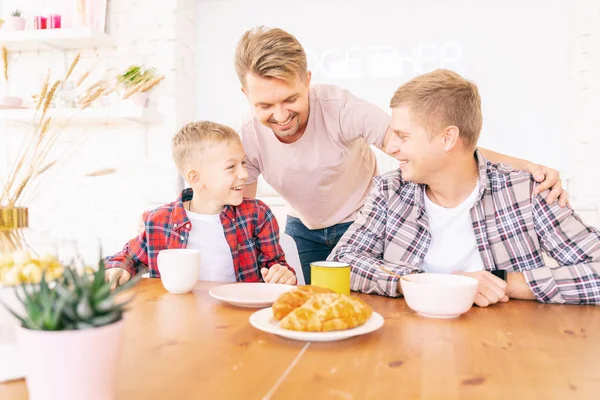 Щасливі молоді батьки і син поснідали на кухні, гей-ф — стокове фото