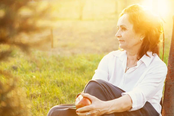 Happy senior woman relaxing on green lawn. Close up face of a ma — Stock Photo, Image