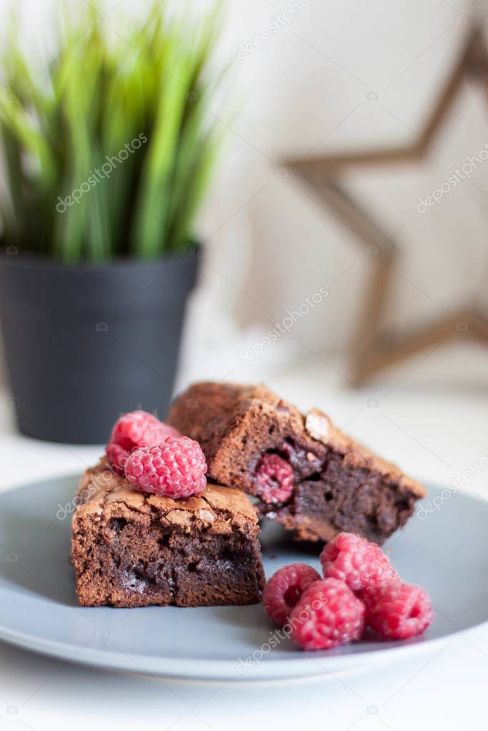 Portioned brownie with raspberry slices