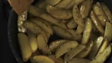 Appetizing potato cooking in frying pan