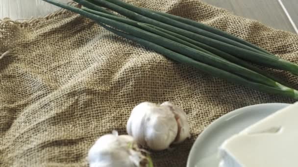 Big Piece Butter Garlic Green Onion Sackcloth Background — Stock Video