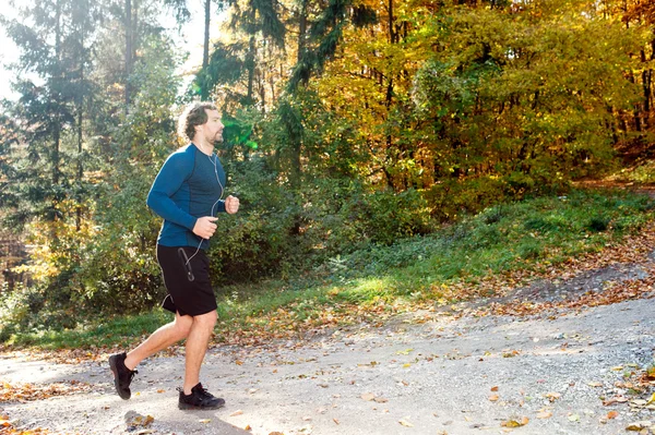 Young runner in autumn nature — Stock Photo, Image