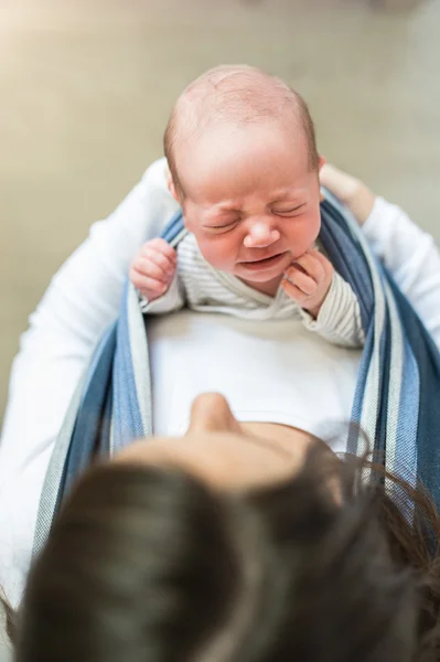 Young mother with her son in sling — Stock Photo, Image