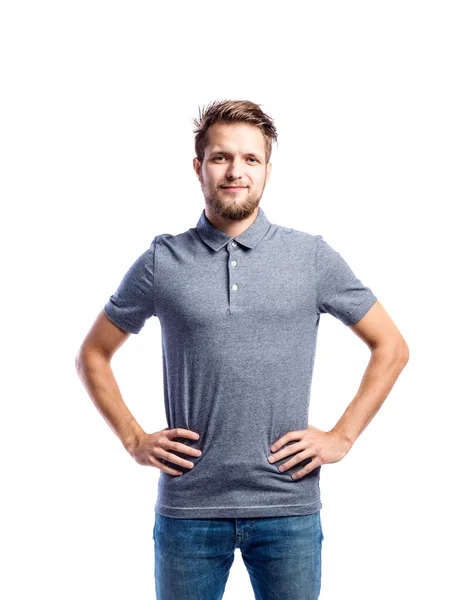Hipster man in jeans and t-shirt, studio shot, isolated — Stock Photo, Image