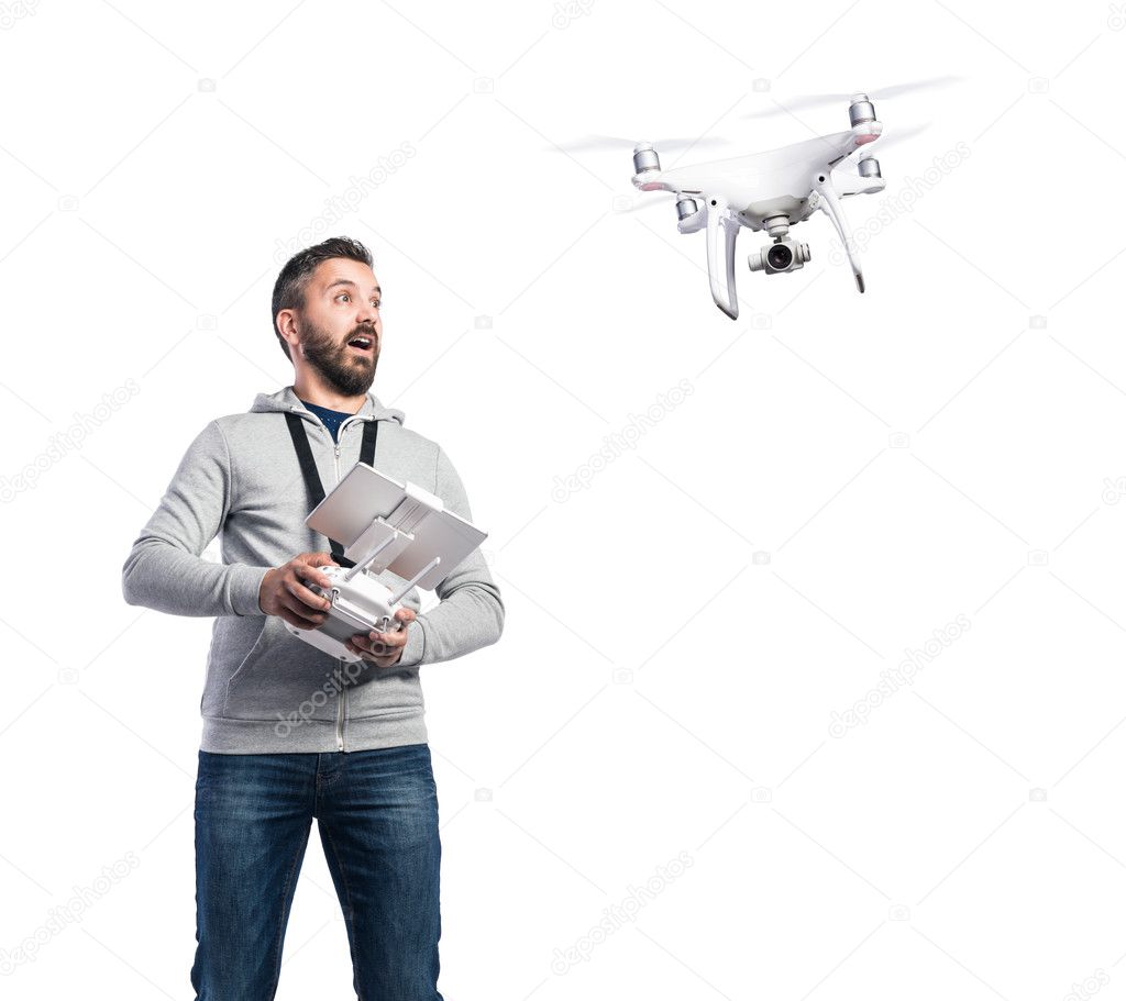 Man with flying drone and remote control