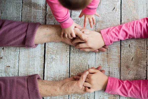 Hands of unrecognizable grandmother and her granddaughters — Stock Photo, Image