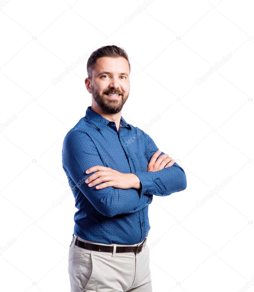 Hipster man in blue shirt, studio shot, isolated