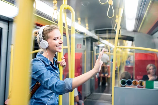 Woman with headphones in subway train — Φωτογραφία Αρχείου