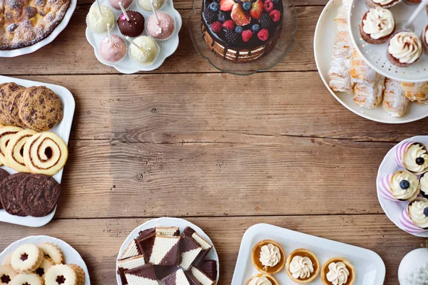 Mesa con pastel, tarta, cupcakes, tartas y pastelitos. Copiar espacio . — Foto de Stock