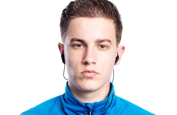 Teenage boy with earphones, in blue sports sweatshirt. Isolated. — Stock Photo, Image