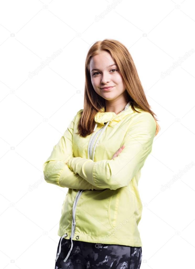 Girl in yellow running jacket and fitness leggings, isolated