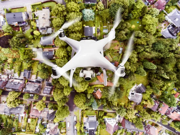 Hovering drone taking pictures of Dutch town. Aerial view.