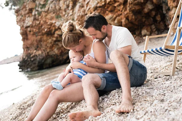Οικογένεια με γιο στην παραλία, απολαμβάνοντας χρόνο στο παραθαλάσσιο. — Φωτογραφία Αρχείου