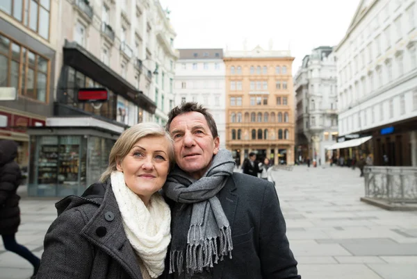 Όμορφο ζευγάρι ανώτερος σε έναν περίπατο στο κέντρο της πόλης. Χειμώνας. — Φωτογραφία Αρχείου