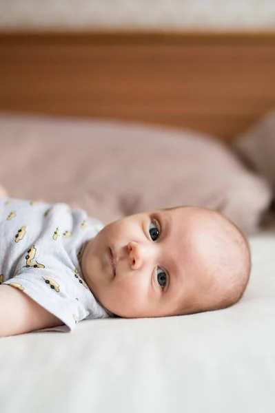 Cute newborn baby boy lying on bed, close up — Stock Photo, Image