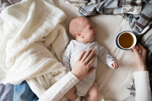 Felismerhetetlen anyja újszülött fiával ágyon — Stock Fotó