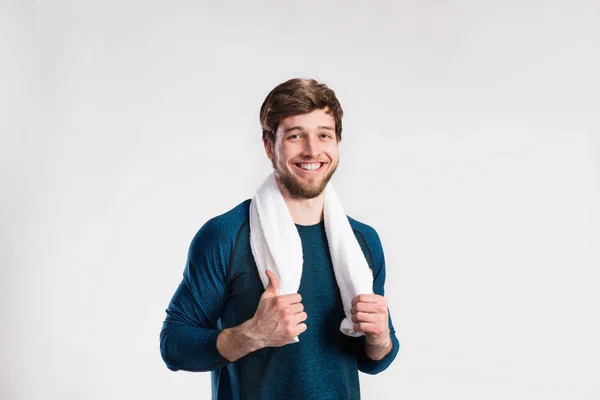 Handsome fitness man resting after working out, towel around nec — Stock Photo, Image