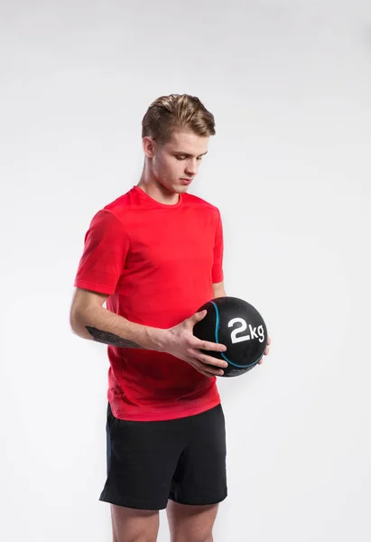 Handsome fitness man holding medicine ball, studio shot. — Stock Photo, Image