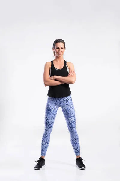 Donna fitness in canotta nera e leggings sportivi, ripresa in studio — Foto Stock