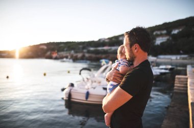 Adam bebek oğluyla deniz onların zaman zevk.