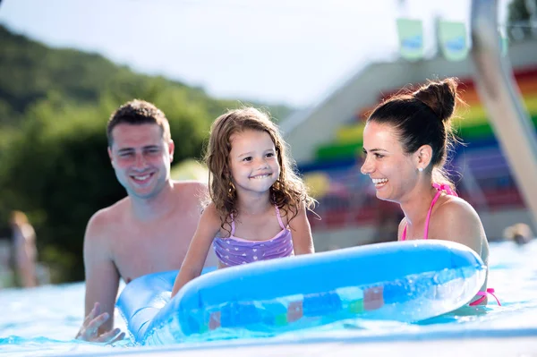 Madre, padre e figlia in piscina. Estate soleggiata . — Foto Stock