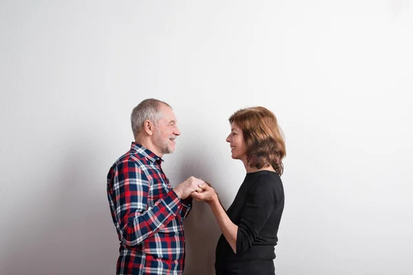 Beautiful senior couple in love holding hands. Studio shot. — Stock Photo, Image