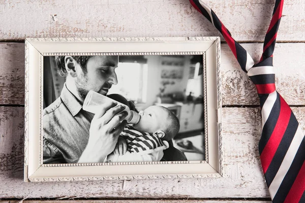 Picture of father feeding baby son. Fathers day. Studio shot. — Stock Photo, Image