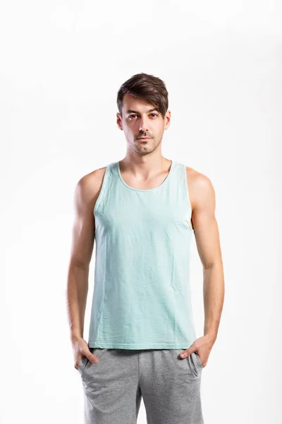 Handsome fitness man in blue tank top shirt, studio shot. — Stock Photo, Image