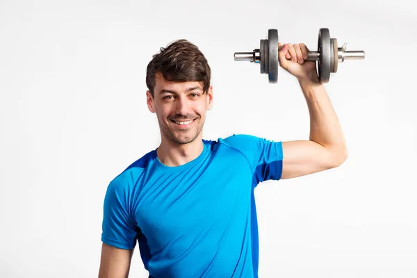 Fitness man håller hantel, träna, studio skott. — Stockfoto