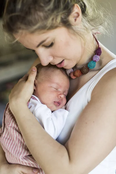 Jeune mère à la maison tenant sa fille nouveau-née — Photo