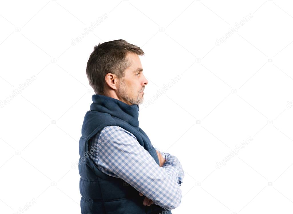 Mature hipster man in shirt and winter vest. Studio shot, isolat