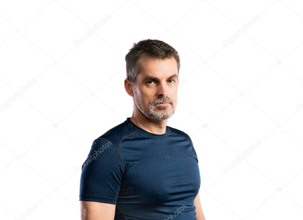 Mature hipster man in blue t-shirt. Studio shot, isolated.