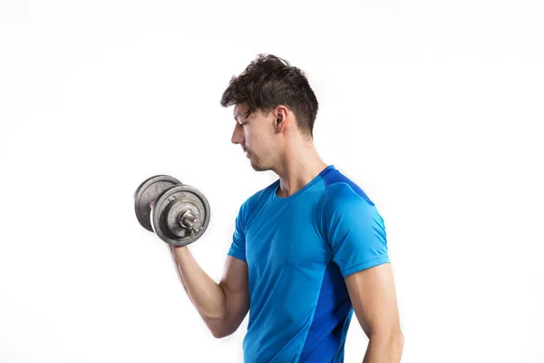 Fitness man holding dumbbell, working out, studio shot. — Stock Photo, Image