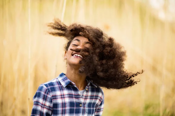 屋外フィールドでチェックのシャツでアフリカ系アメリカ人の女の子. — ストック写真