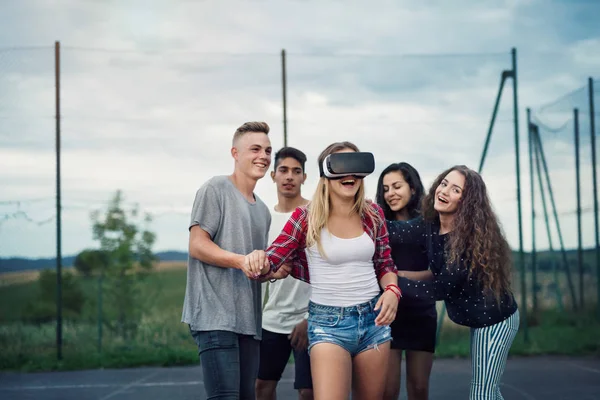 Attractive teenagers on playground. Girl with VR glasses. — Stock Photo, Image