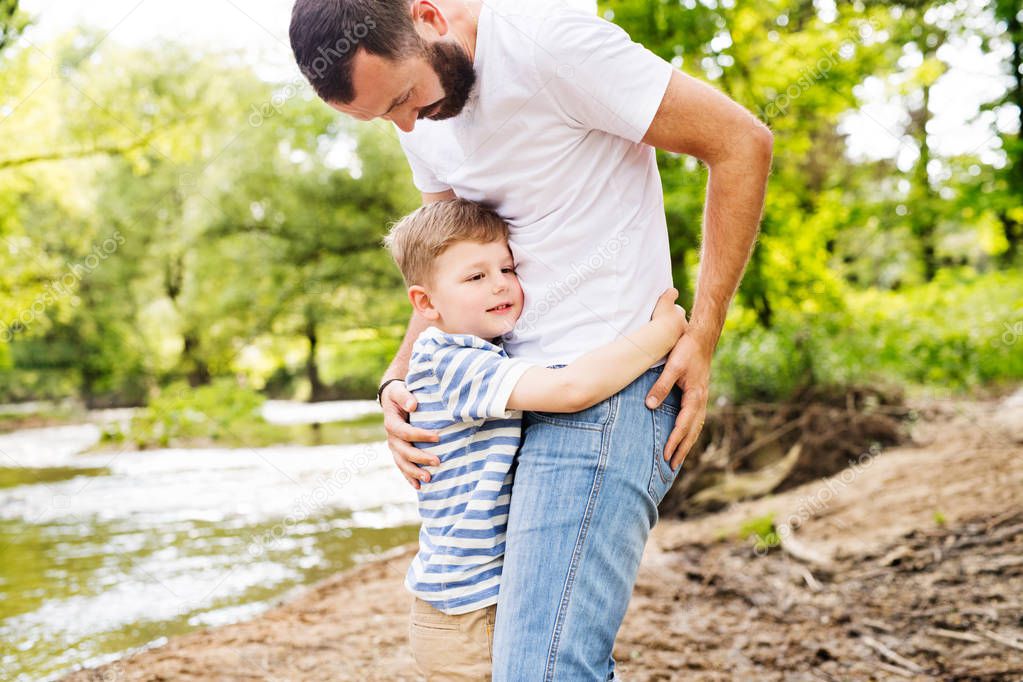 Young father with little boy, sunny spring day.