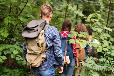 Gençler ormanda hiking sırt çantaları ile. Yaz tatili.